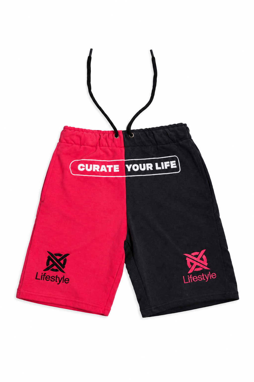 A pair of unisex drawstring shorts split vertically into bright pink magenta and black halves, featuring a white graphic text print on the pink side and a pink logo on the black side, displayed against a plain white background.